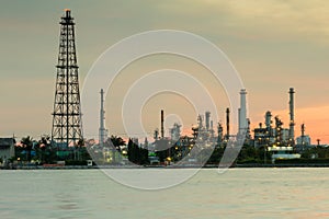 Oil refinery water front with sunrise sky background