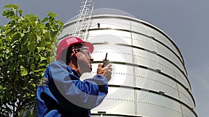 Oil Refinery Worker Using Walkie Talkie