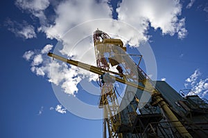 Oil rig on blue sky background