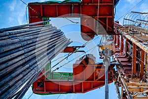 Oil rig derrick in oilfield against the bright blue sky. Drilling rig in oil field for drilled into subsurface in order
