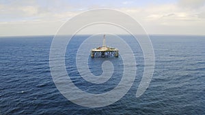 Oil, rig and drone in landscape with ocean, industry and mining offshore with drill on platform. Industrial, fuel and