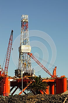 Oil- rig in harbor against blue sky