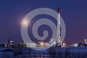 Oilfield in winter night time photo