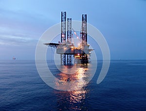 Oil rig before sunrise photo