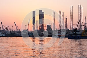 Oil rigs at sunset, Sharjah, Uae photo