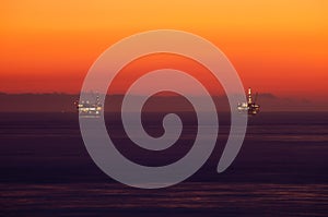 Oil rings in sea at sunset