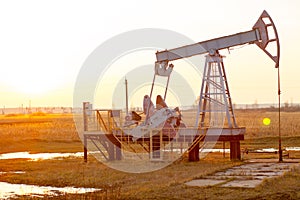 Oil rocking chair. Oil production in Russia, Republic of Bashkortostan. Industrial landscape. Autumn