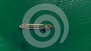 Oil Ship tanker or Liquid fied Petroleum Gas (LPG) sailing in green sea aerial top view