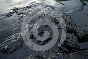 Oil sludge contaminating the sea during the oil spill disaster in Samet Island, Rayong, Thailand