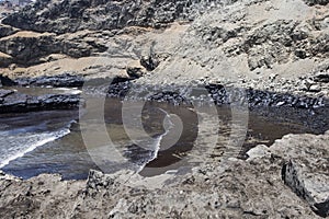 oil spills on the beaches of the pacific ocean with contaminated rocks of repsol company in lima peru in the year 2022