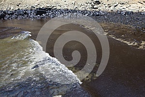 oil spills on the beaches of the pacific ocean with contaminated rocks of repsol company in lima peru in the year 2022