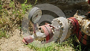 An oil-stained pipeline at an oil field. The concept of environmental pollution