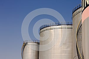 Oil storage tank with metal bridge and stairs