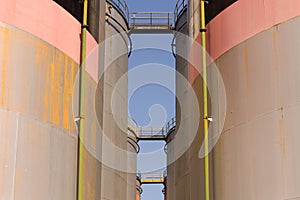 Oil storage tank with metal bridge and stairs