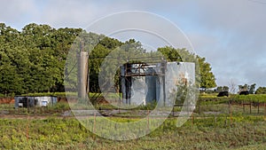 Oil storage tanks and Black Angus cattle in the State of Oklahoma in the United States of America.