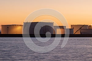 Oil storage tanks at sunset