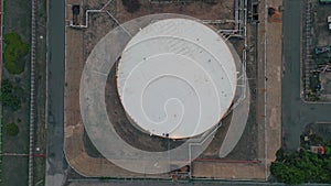 Oil storage tanks top view. Drone flying industrial facility with fossil fuel