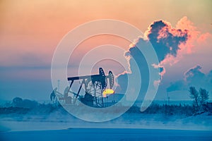 The oil sucking machine lakeside sunrise in winter in Daqing oil fields