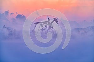 The oil sucking machines in fog sunrise in Daqing oil field
