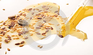 oil and sunflower seeds, flax, sesame seeds on a white background. The concept of a healthy vegetarian diet, detox. Flat