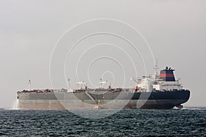 Oil supertanker ship at sea with pilot boat.