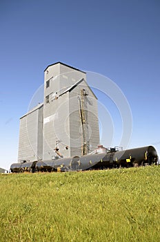 Oil tank cars in from of old grain elevator