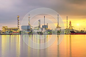 Oil tank ship mooring in oil refinery industry at twilight time