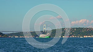 Oil tanker makes its passage through the Bosphorus Strait, a vital maritime route, juxtaposing the natural beauty with