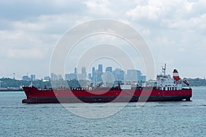 Oil tanker ship anchored in front of the Singapore downtown.