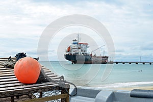 Oil tanker ship at dock with lobster pot trap and buoy Picnic C