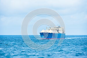 Oil tanker ship sailing through calm, blue waters.