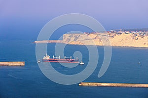 Oil tanker ship with tugboat assistant photo
