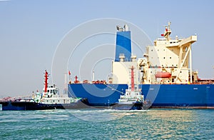 Oil tanker and tugboats