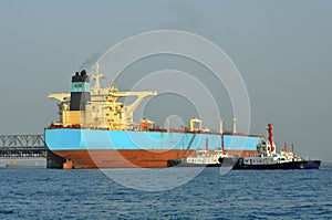 Oil tanker and two tugboats