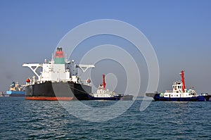 Oil tanker and two tugboats