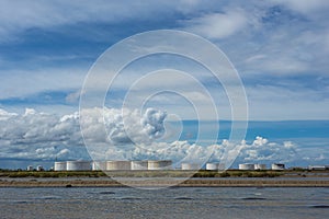 Oil tanks in a row under blue sky, Large white industrial tank f