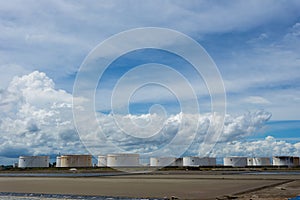 Oil tanks in a row under blue sky, Large white industrial tank for petrol, oil refinery plant. Energy and power