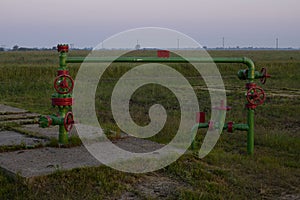 Oil valves and piping. production wellhead. A natural oil well. Horizontal view of a wellhead with valve armature. Oil and gas