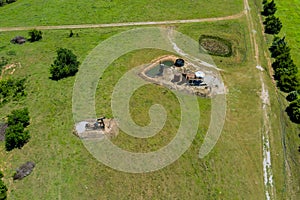 Oil well pump jack working pump jack out in field of grass with of Oklahoma