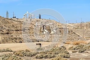 Oil wells on a dry hilly landscape on a clear autumn day