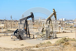 Oil wells under a blue autumn sky