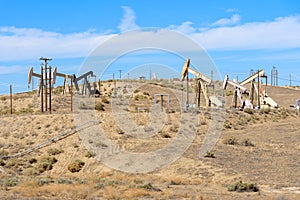 Oil wells under clear sky in autumn