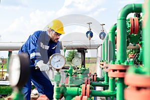 Oil worker is checking the oil pump