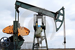 Oil worker climbs