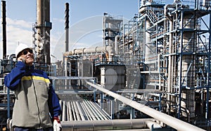 Oil worker inside large chemical refinery