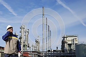 Oil workers with large refinery