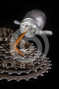 Oiling the bicycle chain with an oil can on the workshop table. Servicing of bicycle parts