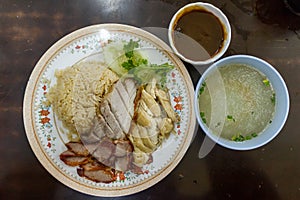 Oily Rice with BBQ Pork, Crispy Pork and Boiled Chicken. Served with Sauce and Soup