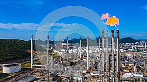 Oilâ€‹ refineryâ€‹ andâ€‹ petrochemicalâ€‹ plant industrial working with fire and blue sky background, Aerial view oil and gas