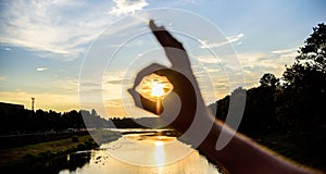 Ok gesture sign of best choice approve and confirm. Silhouette ok hand gesture in front of sunset above river water